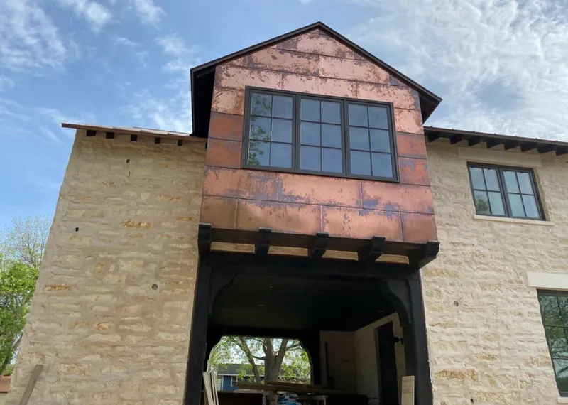 Copper metal panel facade on a stone building for Skylight Installation in Deerfield